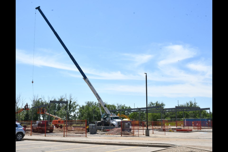A crane was recently on site at Thatcher Crossing, as crews worked to erect a new strip mall. Photo by Jason G. Antonio