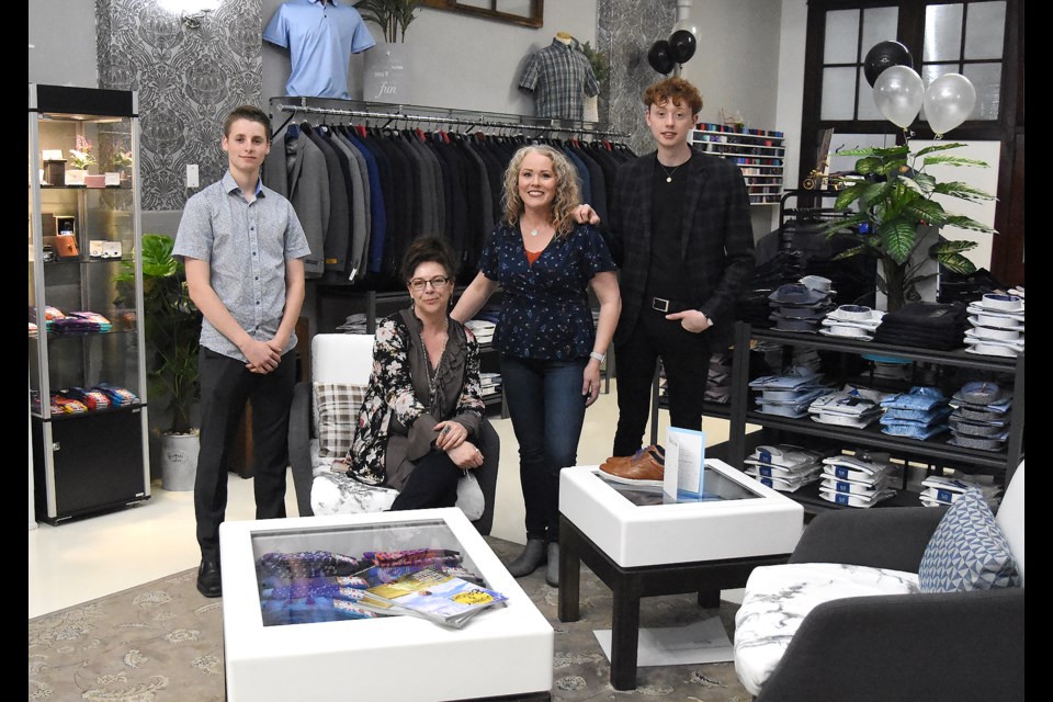 Trinos' Phillippe Levesque, manager Kim Martin, owner Trina Johnson and Keaton Fader pause for a photo during their grand opening