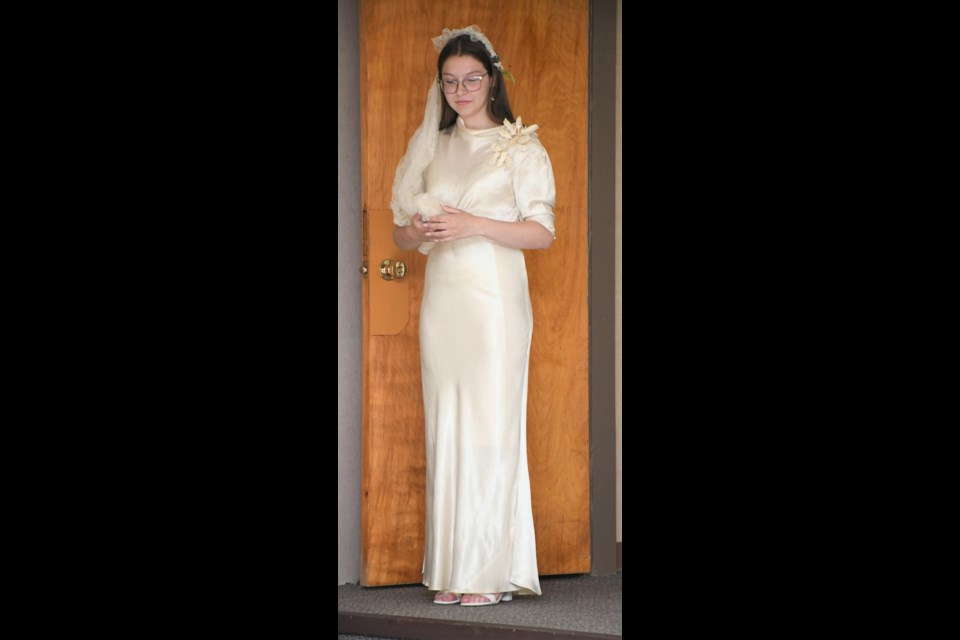 Emma Viczko showcases a dress that Eve (Bolen) Kaip wore during her wedding on July 8, 1935. Photo by Jason G. Antonio