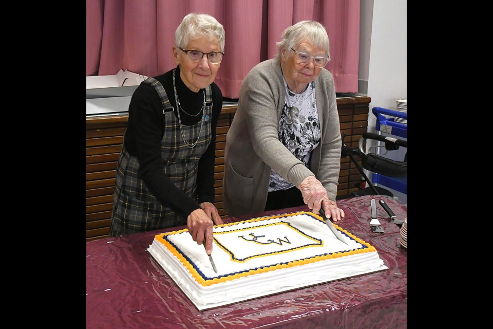 Vivian Wilson and Vivian Francis -- both members of the United Church Women for 60 years -- cut the cake during the 60th anniversary celebration.
