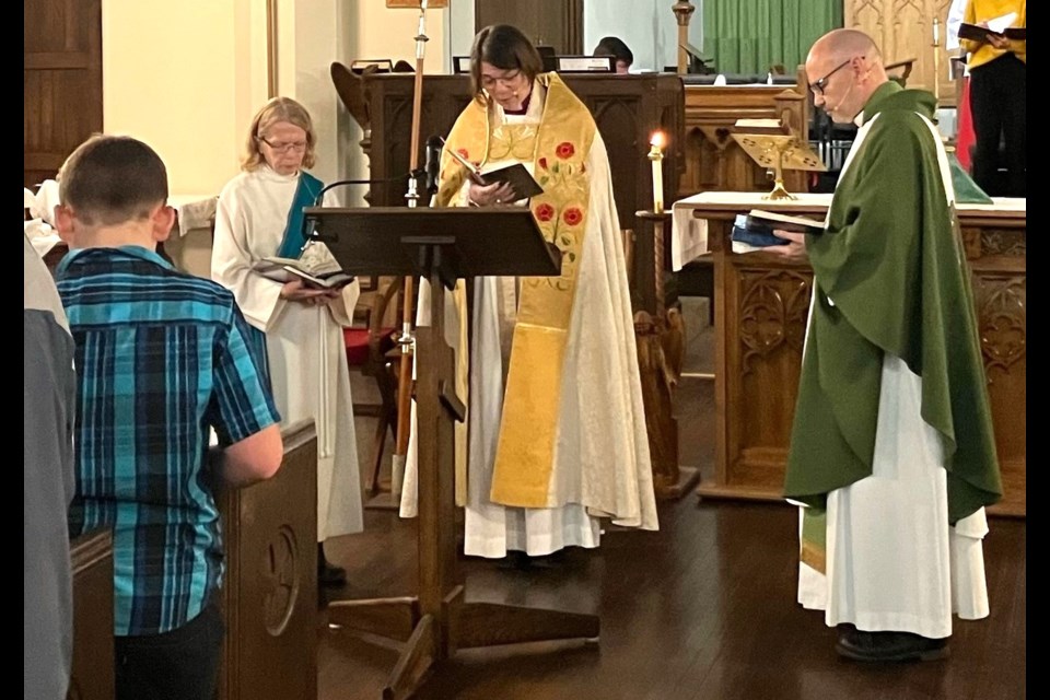 Bishop Helen Kennedy (centre) leads the special anniversary service while assisted by Deacon Arleen Champion and Rev. Dean Pinter. Photo by Michelle Josefson