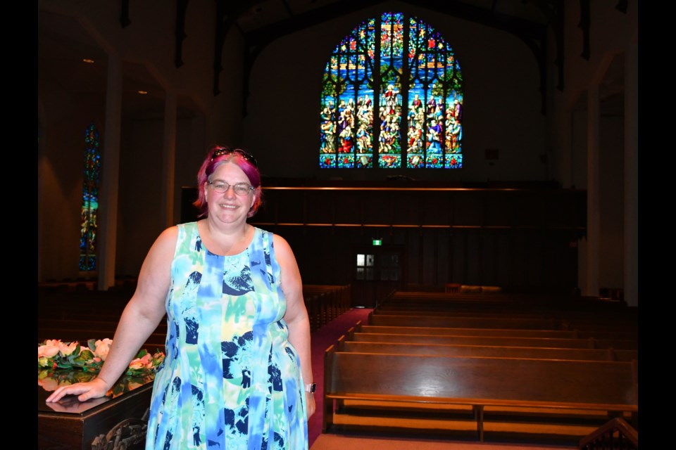 Heather Milligan Stevens, the office administrator at St. Andrew's United Church, gathers in the sanctuary, a few days before the church holds its final service. Photo by Jason G. Antonio