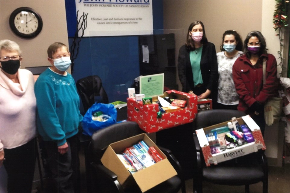 Boxes donated by St. Andrew's. L-R: Barb Erickson (outreach committee), Lynann Pethick (outreach committee), Jody Oakes (JHS branch manager), Meagan Jasper (residential support caseworker), Nica Moore (residential support caseworker)