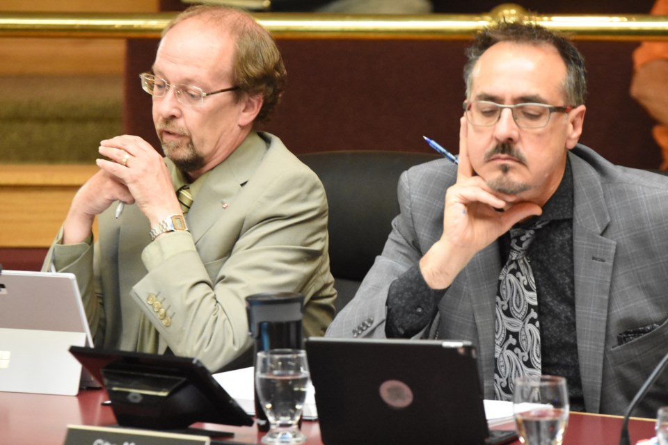 Brian Acker, director of finance, reports to council on how much money was generated by selling more than a dozen financial bonds, while city manager Jim Puffalt reads through the report, during the June 10 regular council meeting. Photo by Jason G. Antonio 