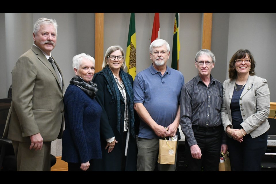 City council has honoured the two men who helped restore the clock glass in the city hall tower. From left are Mayor Clive Tolley, heritage advisory board members Stella Richards and Janie Fries, contractors John Trodd and Murray Rimmer, and Coun. Crystal Froese. Photo by Jason G. Antonio 
