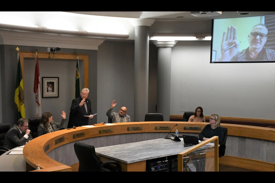 With hands clearly raised, city council re-votes on bylaws related to the joint-use school project. Photo by Jason G. Antonio 