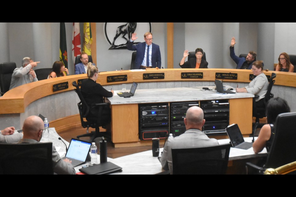 City council votes on a motion to update the zoning bylaw in relation to supportive housing. Voting in favour, from left, are Coun. Jamey Logan, Mayor James Murdock, Coun. Carla Delaurier and Coun. Patrick Boyle. Photo by Jason G. Antonio