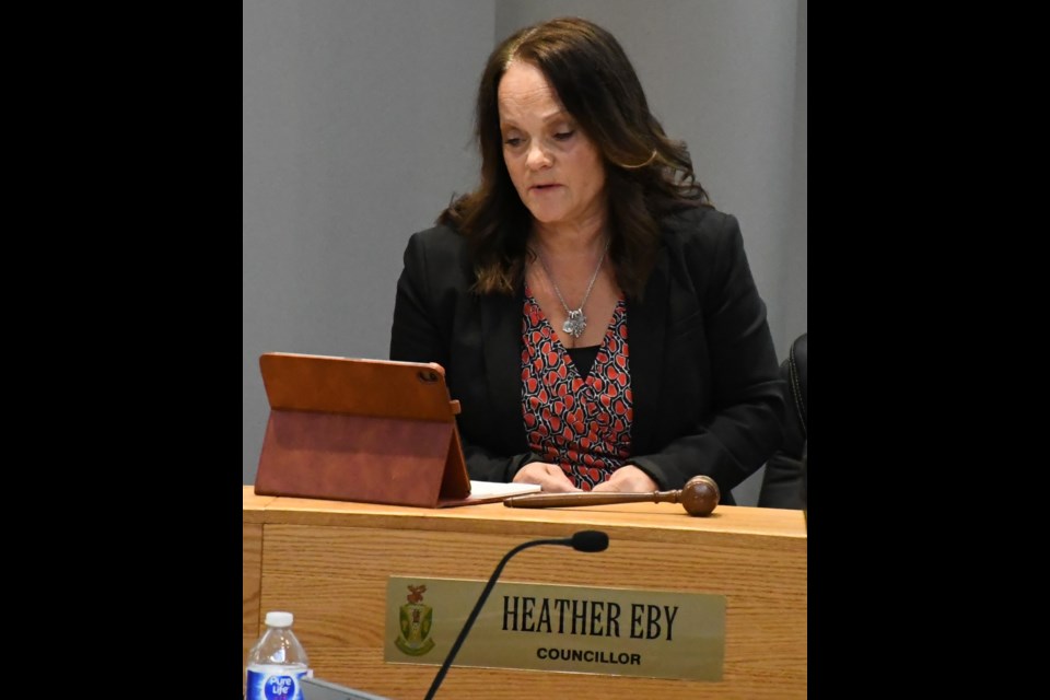 Coun. Heather Eby reads her motion during the council meeting. Photo by Jason G. Antonio