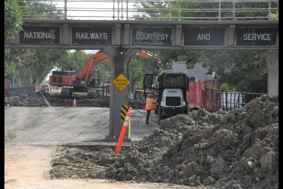 Construction crews install underground water and sewer pipes on Fairford Street East. Photo by Jason G. Antonio 