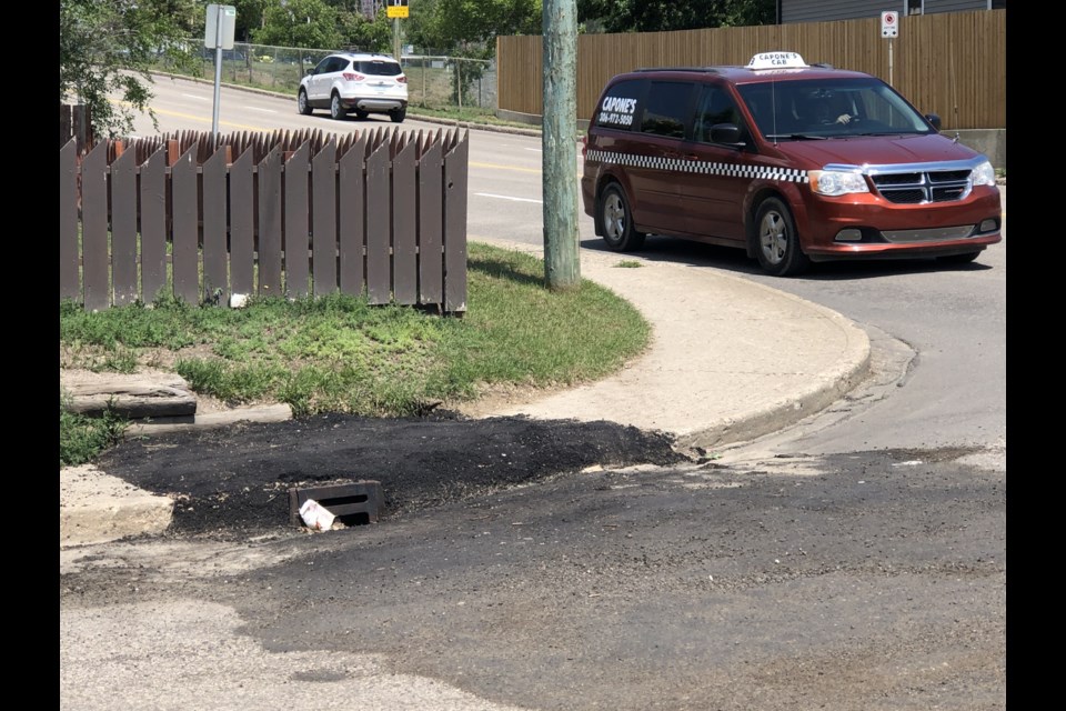 City crews fixed a catch basin and connecting pipe at the corner of Ninth Avenue Northwest and Athabasca Street West recently, but a nearby resident has criticized the work. Photo by Jason G. Antonio