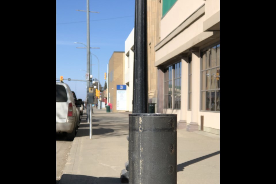 A parking stall with a missing parking meter head. Photo by Jason G. Antonio