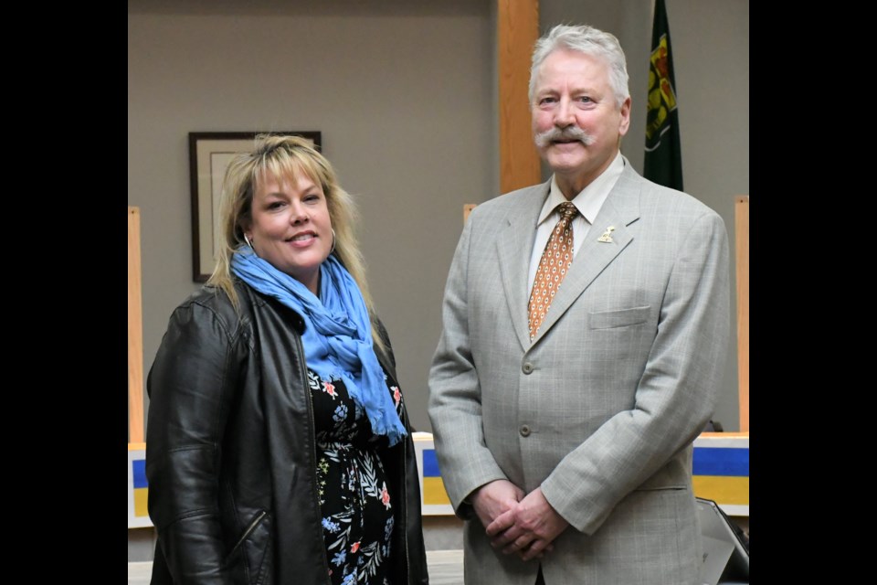 Staci Dobrescu, public works supervisor (water) with the City of Moose Jaw (left), poses with Mayor Clive Tolley after being recognized during the March 14 council meeting for winning an award during the annual convention of the Saskatchewan Public Works Association. Photo by Jason G. Antonio 