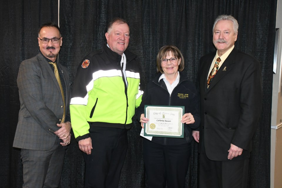 Cathie Bassett with the fire department (second from right) receives a certificate and award for her 25 years with the city. Presenters included, from left, city manager Jim Puffalt, Fire Chief Rod Montgomery and Mayor Clive Tolley. Photo by Jason G. Antonio