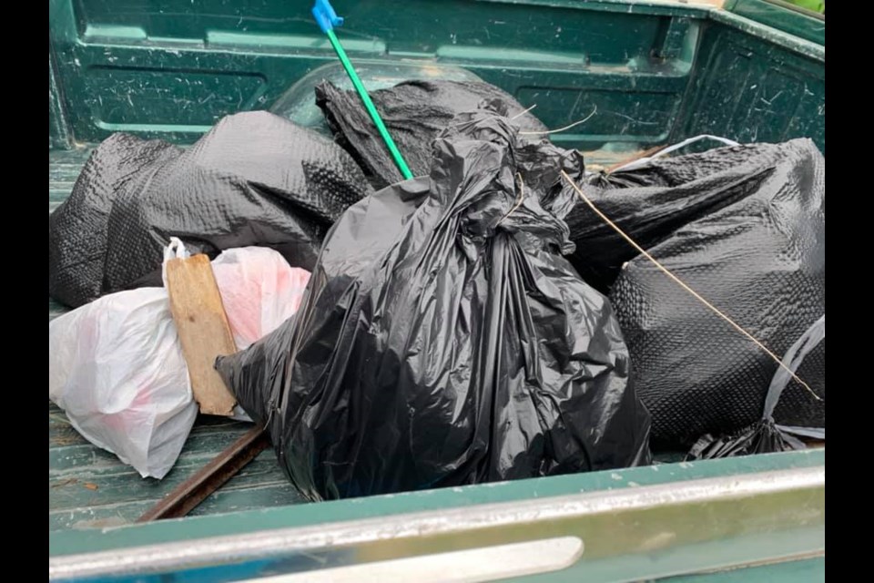 A pickup truck filled with garbage bags from a past community cleanup event on South Hill. Photo courtesy Facebook