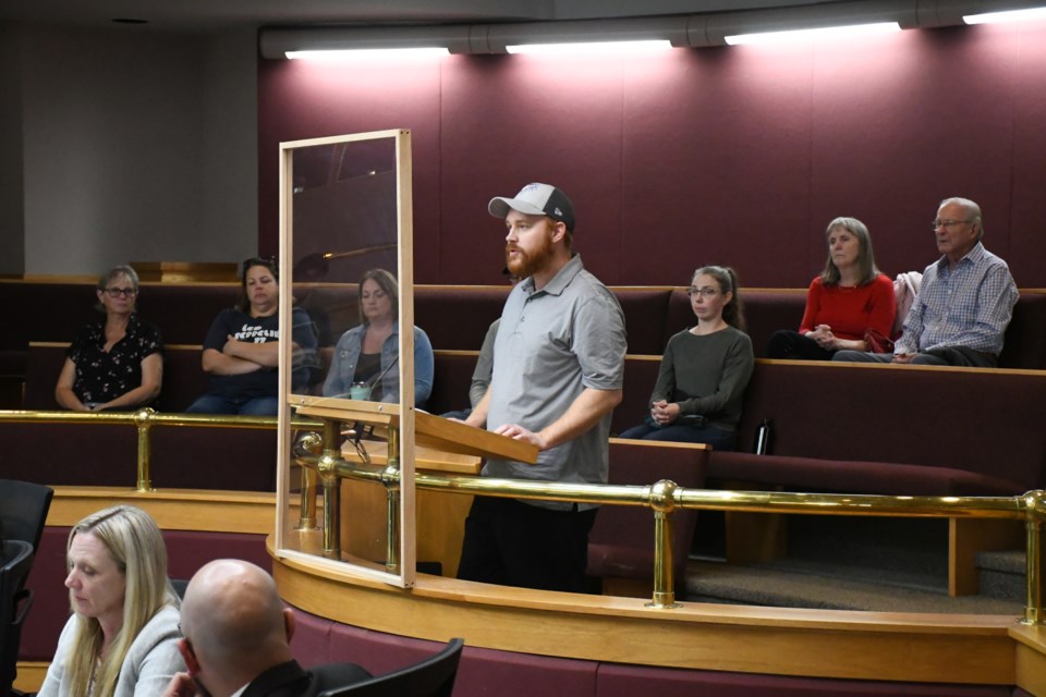 Jamie Wallace speaks to council about proposed zoning changes to 476 Stadacona Street East, with concerned neighbours behind him. Photo by Jason G. Antonio