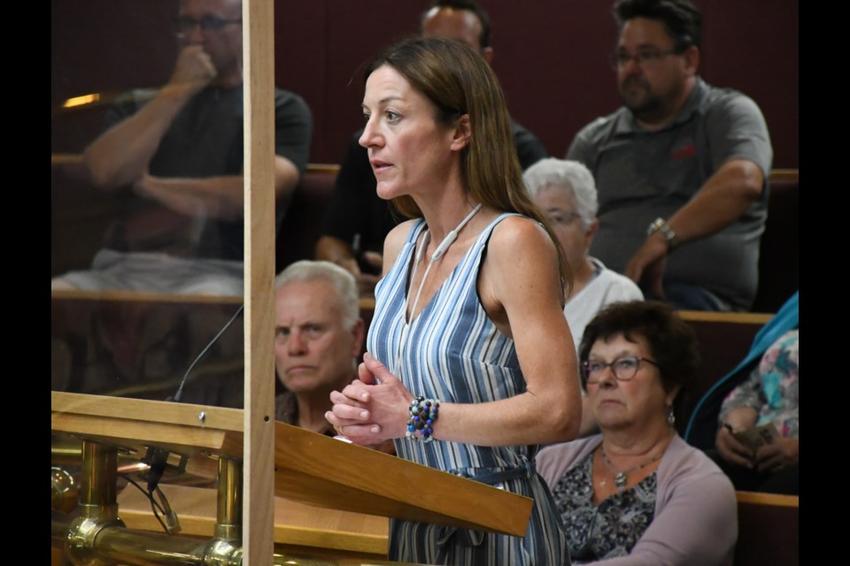 Property manager Kristy Van Slyck speaks to city council during its Aug. 14 meeting. Photo by Jason G. Antonio