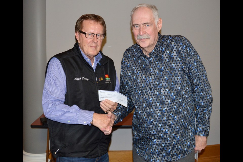 Lloyd Luhning, vice president of the Early Bird Lions Club, left, presents Lyle Johnson, chairman of Moose Jaw Crime Stoppers with a cheque for $500. (Matthew Gourlie photograph)