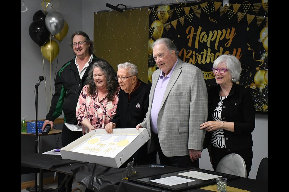 Al Cameron is joined by friends and family before cutting his birthday cake.