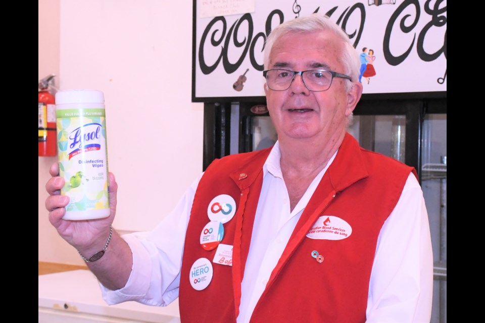 Bob O’Reilly, a volunteer with Canadian Blood Services, is ready to keep the refreshment area clean, during the recent CBS blood donor clinic on April 7. Photo by Jason G. Antonio