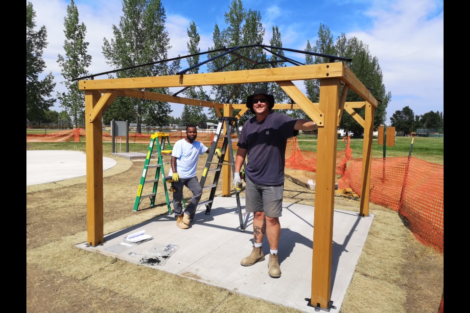 Abdul Ali (left) and Blueprint Builders Ltd. owner Jordan Moser (right) have almost completed the gazebos at the new spray park.  