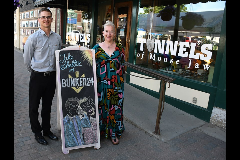 Tunnels of Moose Jaw business manager Kelly Carty and general manager Bobby Hill pose with the Bunker 24 street sign during the tour’s grand opening. 