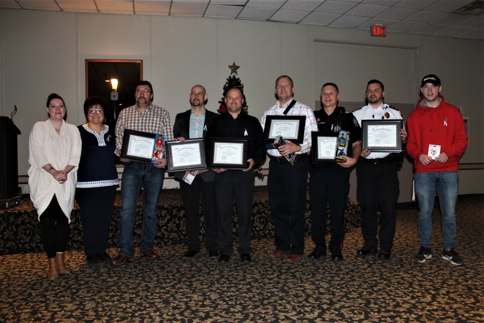 L-R: Transition House director Jenn Angus; Transition House supervisor Marlene Borthwick; Darrell Andrei; Geoff Anderson; Chad Topp; Sgt. Time Schwartz; Sgt. Kevin Pilsworth; Kyle Sereda; Blaze Bailee. 