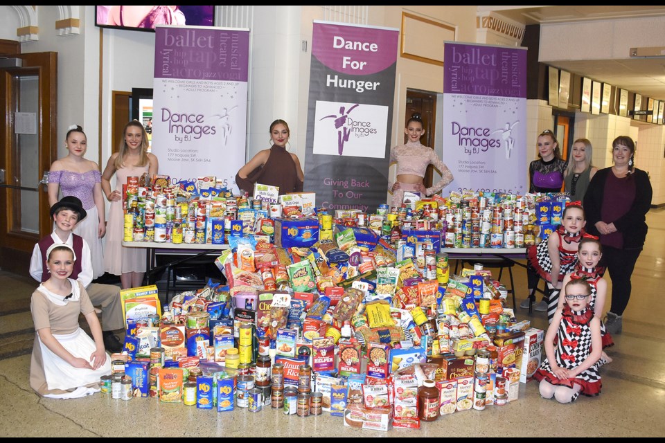 Performers with Dance Images by BJ show off their massive haul of donations headed for the Moose Jaw and District Food Bank.