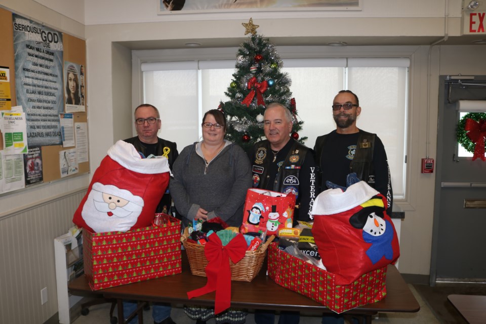 The UN-NATO Veterans Moose Jaw group donates food, clothes and toiletries to Riverside Mission on Thursday. Roy Kilbride, Don McDonald and regional vice-president Bud Roy presented the donation to Rachel Mullens, second from the left, manager of Riverside Mission. Photo by Shawn Slaght
