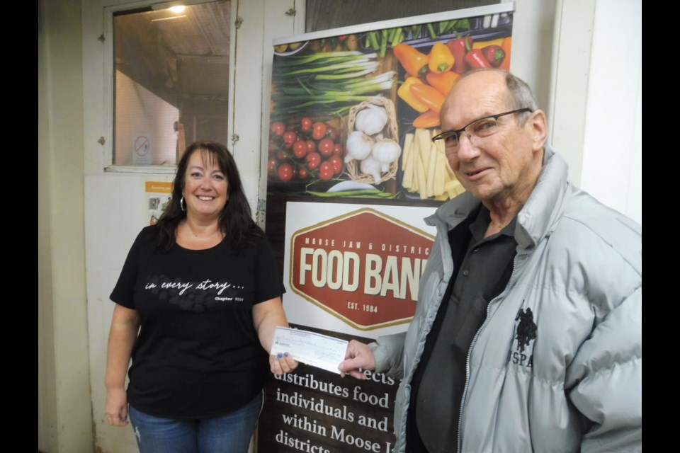Charity Committee Chairman Chris Svab presents a cheque to Deann Little of the Moose Jaw & District Food Bank. (submitted)