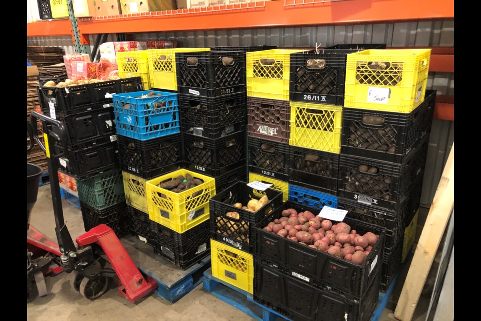 The food bank received 14 pallets of potatoes as a donation from Second Harvest in Saskatoon. The organization now has a few pallets left, with the potatoes in crates. Photo by Jason G. Antonio