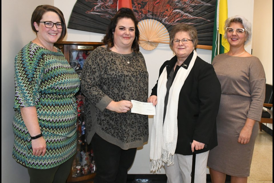 The Moose Jaw Multicultural Council's Jaella Wiebe and Stefanie Palmer accept a $28,000 cheque from Jean Tkatch and Amy Jane Lunov of the former St. Vladimir’s Ukrainian Orthodox Church. Photo by Jason G. Antonio 