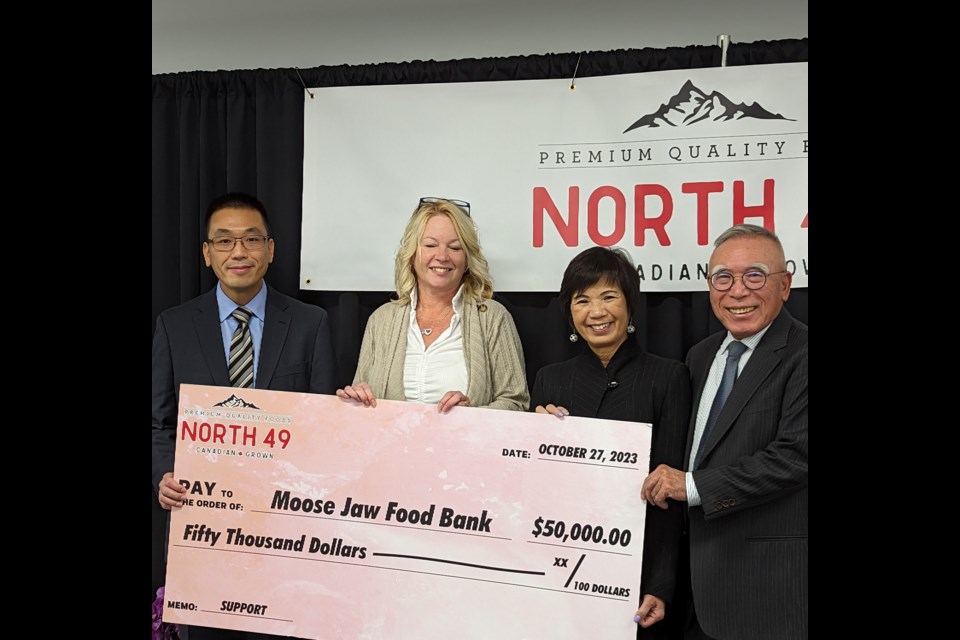 Terri Smith, second from left, accepts a cheque for $50,000 from Allan, Julia, and Donald Leung