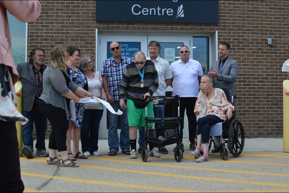 Dignitaries, Staff, Special guests, and Edith’s family members cutting the ribbon