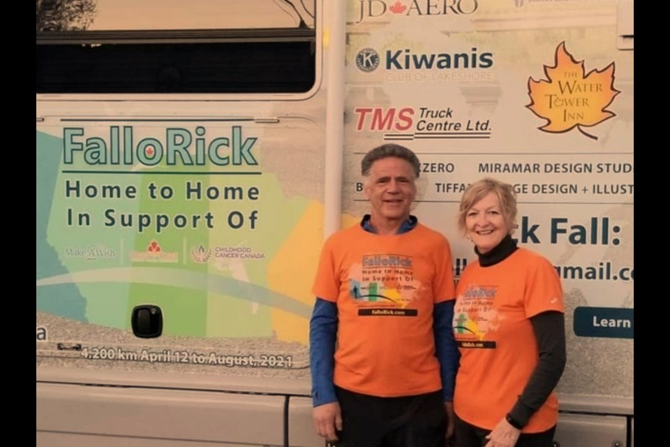 Rick Fall and his wife, Colette, pose in front of the motorhome they are using as part of his cross-Canada marathon to raise money for childhood cancers and illnesses. Photo courtesy Rick Fall