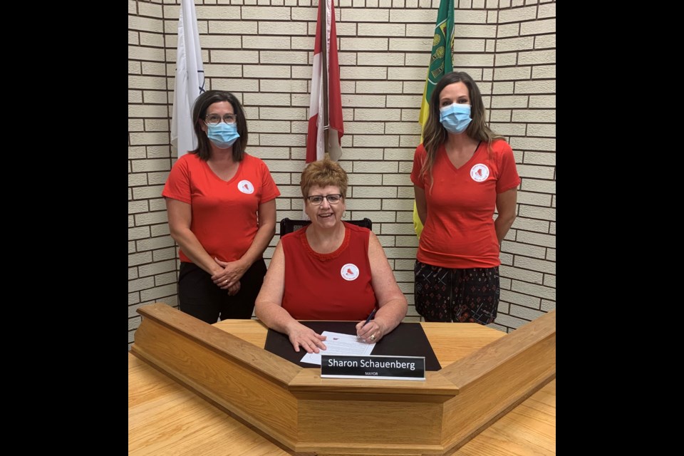 Assiniboia Mayor Sharon Shauenberg (seated) and committee members Jill Zahariuk and Christine Printz pose for a picture after the mayor signed a proclamation recognizing Fetal Alcohol Spectrum Disorder awareness day on Sept. 9. Photo submitted