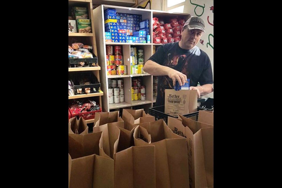 Ian Little prepares a hamper at the Moose Jaw and District Food Bank.