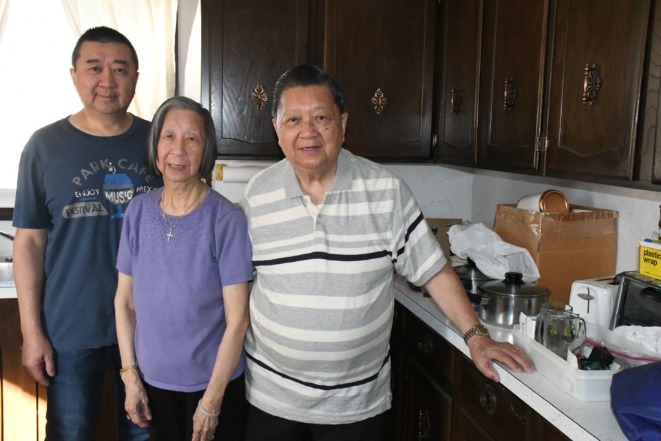 Gale Chow (right) poses with his wife Myrna and son Kyle in the family home. The Chows will soon move to Regina to live with their son. Photo by Jason G. Antonio 