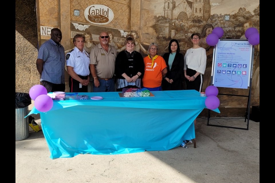 Jide Kassim (far left) administrative and communications coordinator for Prairie Skies Integration Network and Dalise Hector (far right) stand with a number of community partners who will be working with them to assist newcomers to the area. 