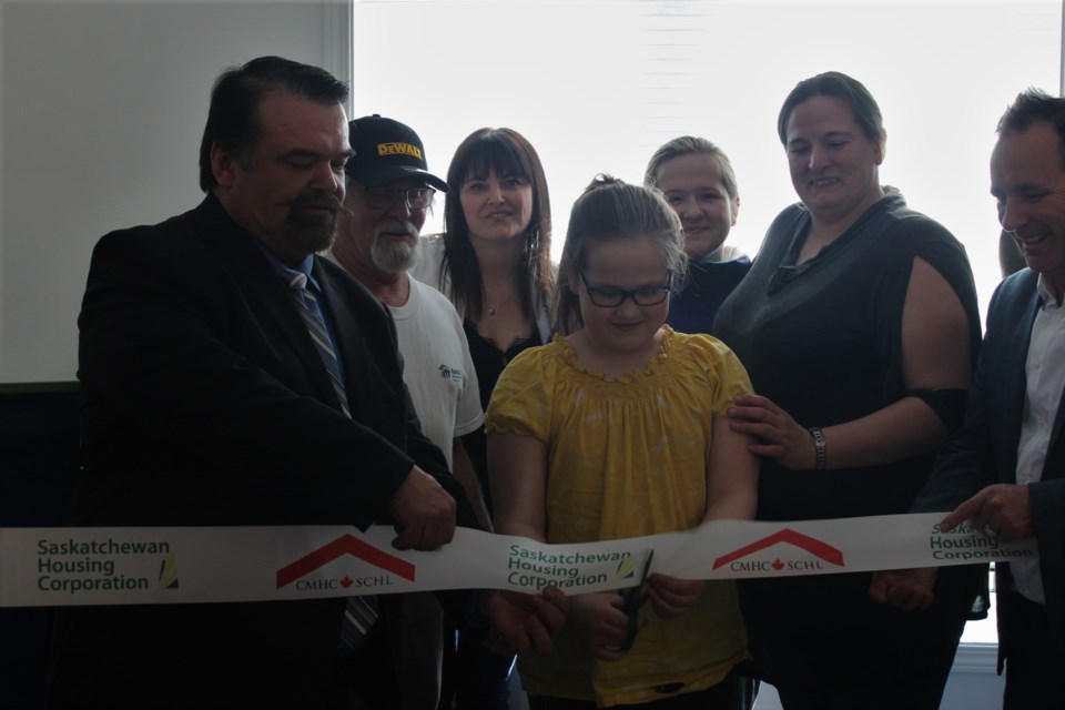 Nine-year-old Chelsea, surrounded by dignitaries and her mother and sister, had the honour of cutting the ribbon to officially declare her new family’s home finished.