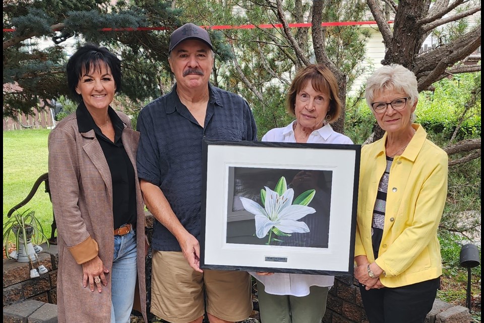 (l-) Angela Sereda, chair of HHMJ; Jim and Sandi Connolly and their giclee reproduction of Yvette Moore's 'Petals of Hope'; Glenny Eberts, a longtime family friend of the Connolly's whose hospice advocacy was a major factor in the family's donation