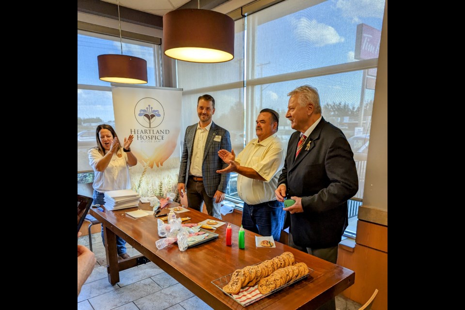 (l-r) MLAs Tim McLeod and Greg Lawrence compete against Mayor Clive Tolley to prove that politicians can also decorate with frosting