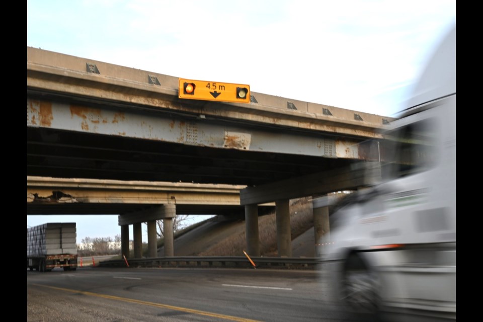 Semi-trucks pass under the Main Street North bridge as they travel east on Highway 1. 