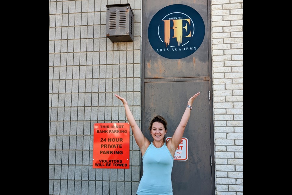 Kyleigh Coad in front of the door that will become the main entrance. Formerly a fire door at the rear of 52 High Street West, renovations should be complete by Aug. 28