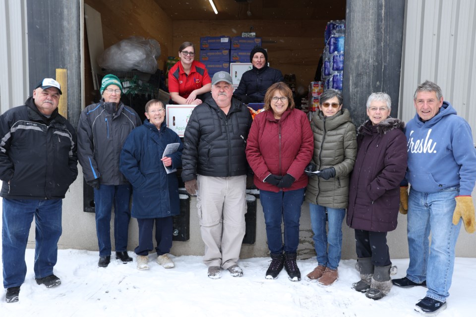 Volunteer members of the Friendly City Optimist Club, along with Produce managers of Moose Jaw Co-op help to load up the truck with apples and oranges for the kids