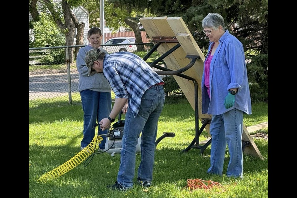 Painting a picnic table. Photo submitted