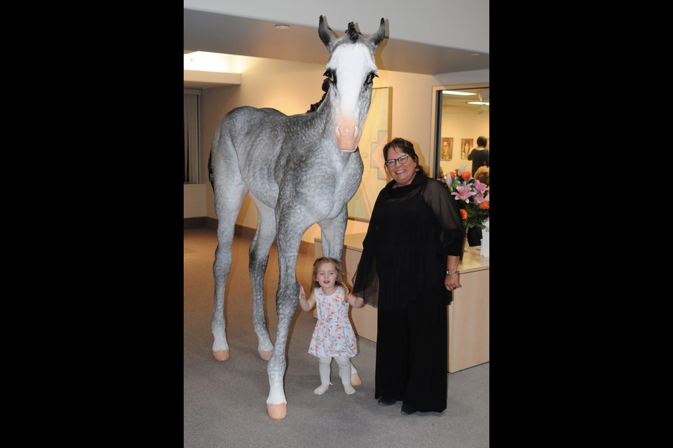 Moose Jaw Museum and Art Gallery administrative director Joan Maier pauses for a photo with Peggy and great-granddaughter Lucy.