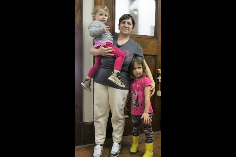 Julia Maksymenko (centre) and her two daughters pose in the office of Amy Jane Chartered Professional Accountant after speaking about her family's ordeal fleeing Ukraine. Photo by Jason G. Antonio  