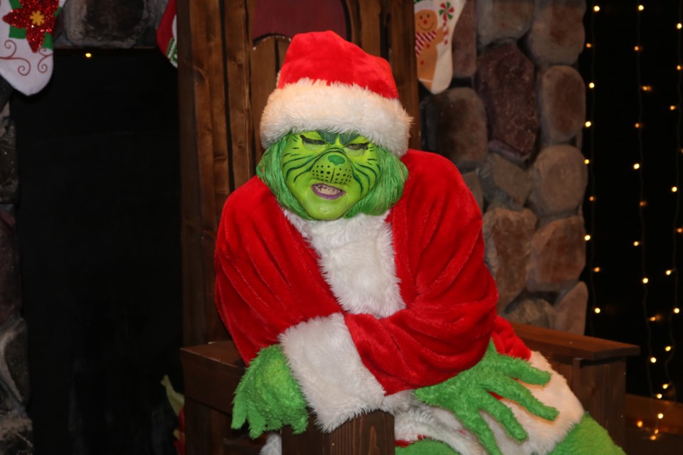 The Grinch patiently waits for kids at The Mean One Wakamow Valley Authority fundraiser on Saturday at the Sportsman’s Centre. Photo by Shawn Slaght