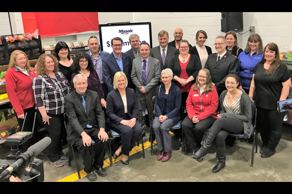 The Mosaic Company pledged $2.5 million to 12 Saskatchewan non-profit organizations over the next three years at an announcement at the Regina Food Bank. Moose Jaw Mayor Fraser Tolmie, centre, was joined by MLA Mark Docherty, front left, and Karen Swager, Mosaic’s new senior vice-president, potash, second from left, front, at the announcement along with representatives from the non-profits. Submitted photograph