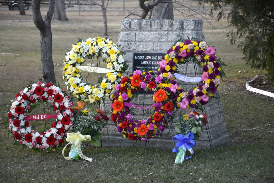 Wreaths are laid alongside the cairn outside the Moose Jaw Union Centre on Thursday afternoon.